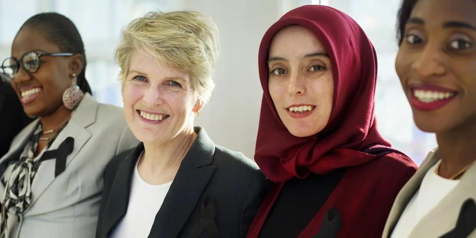 Four women smiling at camera