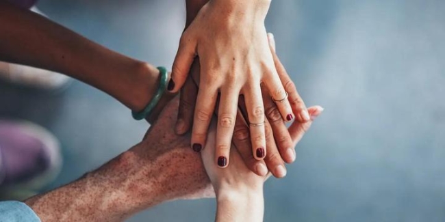 Hands stacked on top of one another