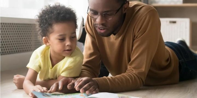 Father and child looking at a book