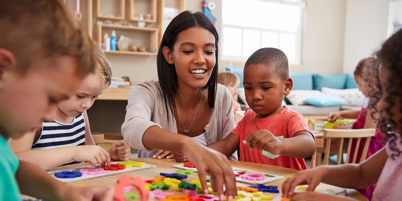 Woman working with kids around a table