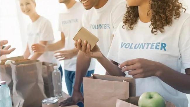 People filling bags of food