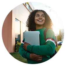 Woman smiling holding a laptop