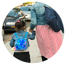 Woman and child walking holding hands