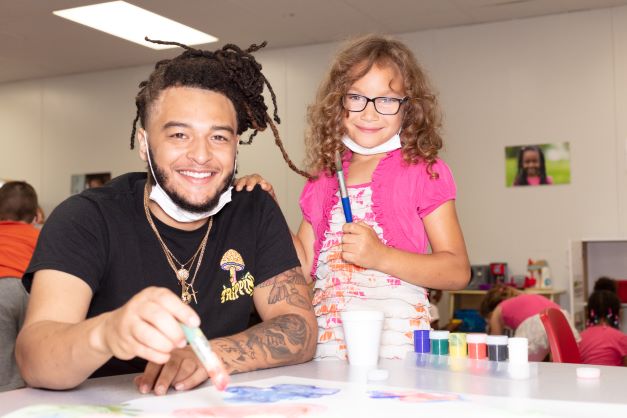 Man and girl smiling at camera