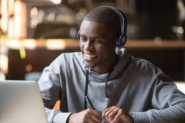 Man seated, wearing headphones