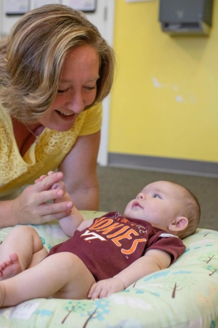 Woman smiling at baby